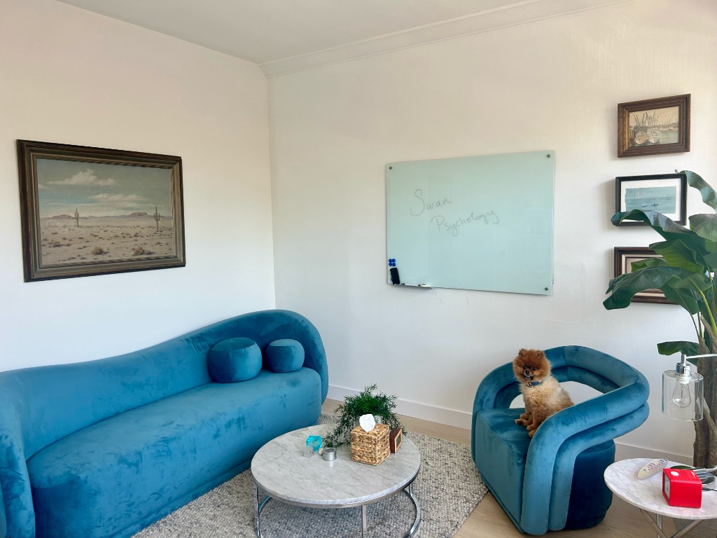 Swan Psychology Beverly Hills therapy office — welcoming consultation room with teal velvet seating, marble coffee table, and Swan Psychology whiteboard